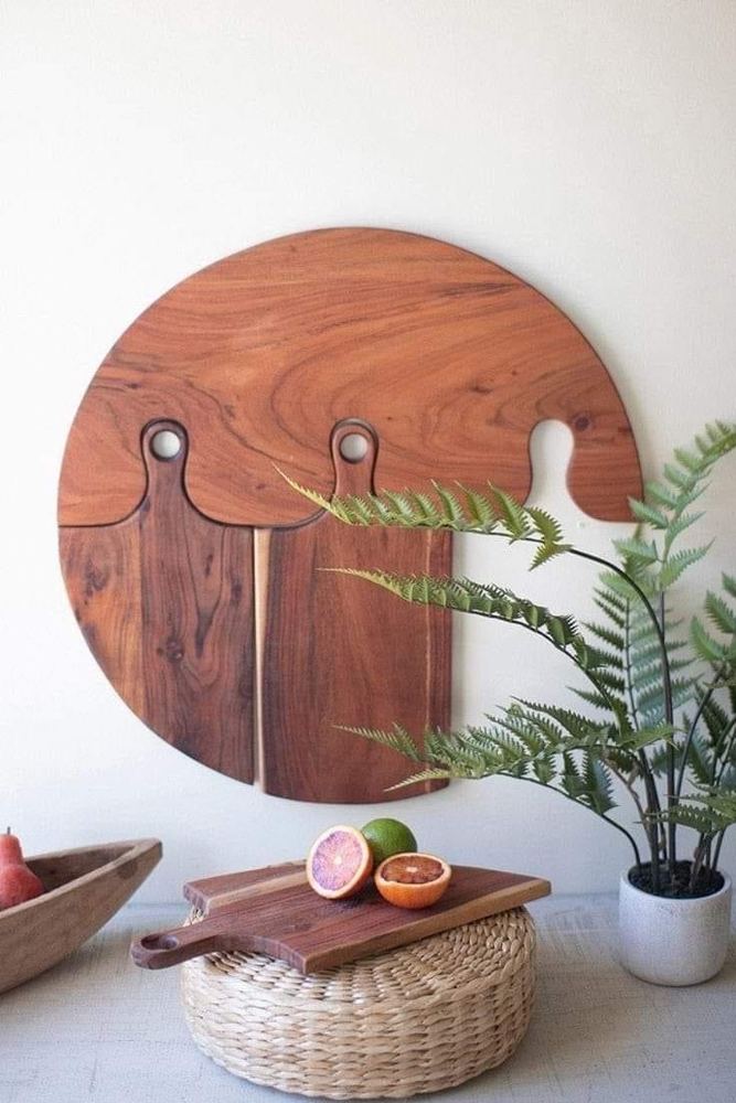 Round hardwood serving and cutting board hung on a wall